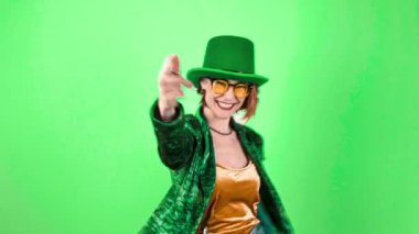 St. Patricks Day leprechaun model woman. Portrait of woman on Patricks Day celebration. Green background