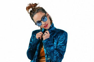 Young woman with glasses on a white background.Charming smiling woman poses against white studio wall. People sincere emotions. Lifestyle concept.