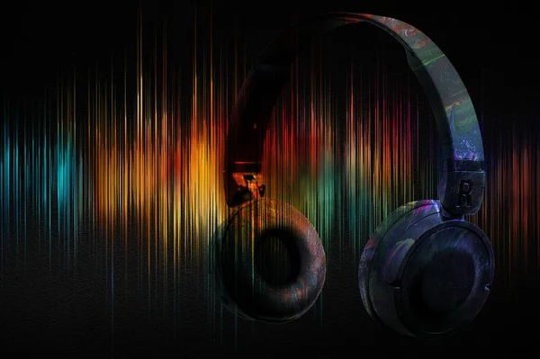 Music headphones on the background of sound wave with spectral colours. Abstract image of musical equalizer.
