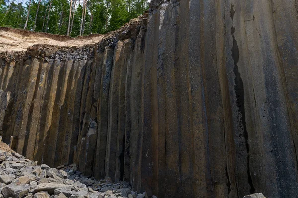 stock image Basalt pillars in a quarry. Natural basalt rock columns closeup texture. Abstract natural background or texture.