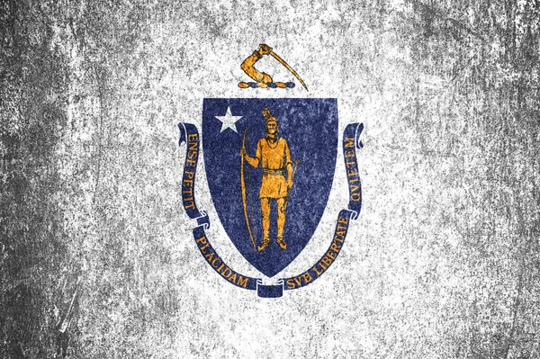 stock image Close-up of the Massachusetts grunge flag. Dirty Massachusetts state flag on a metal surface.