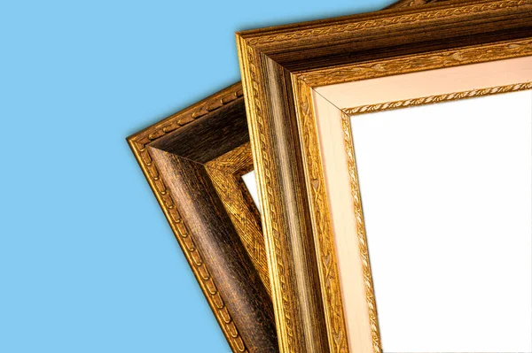 Antique wooden picture frames. Old rustic wooden frames close-up. Antique carved gilded frame. Selected focus