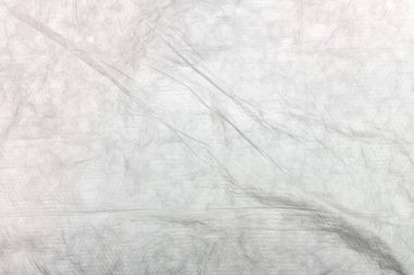 Buruşmuş beyaz bebek bezi. Dokuları beyaz düz çarşafları kapatın. Üst görünüm