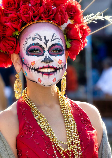 A woman smiles at the 2022 Day of the Dead Festival and Parade in downtownb El Paso, Texas.