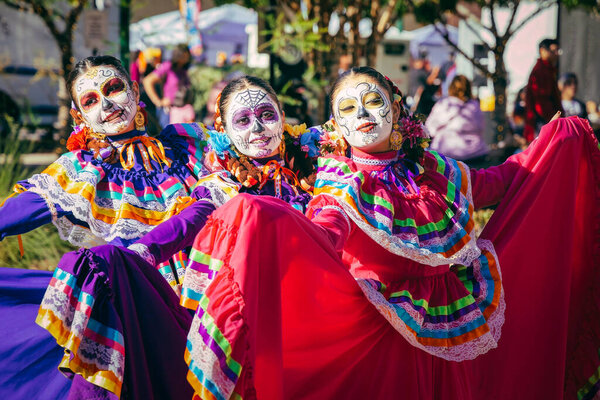 A group of women, wearing traditional Mexican costumes, at the 2022 Day of the Dead Festival and Parade in downtownb El Paso, Texas.
