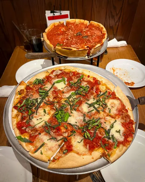 Two pizzas, ready to be eaten, at a restaurant in Chicago, Illinois.