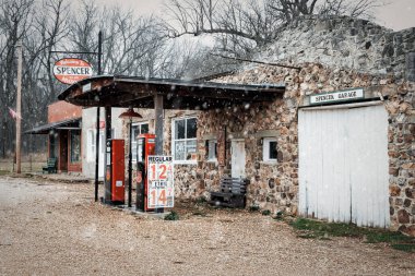 Snow flurries at Spencer Station on historic Route 66 near Miller, Missouri. clipart