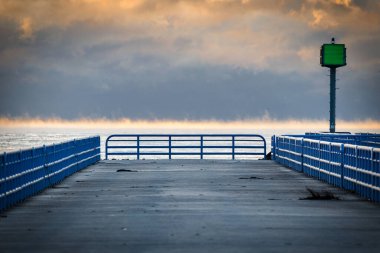 İskelenin sonunda, Michigan Gölü 'ndeki Two Rivers, Wisconson' daki sabah buharına bakıyorum.
