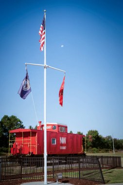 An American flag and train caboose and the Chesapeak City Park in Chesapeake, Virginia.