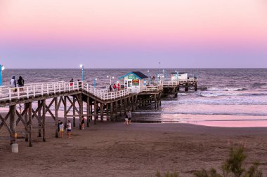 LA LUCILA DEL MAR, BUENOS AIRES, ARGENTINA - JANUARY 12, 2022: View of the famous fishing pier at sunset. Day of summer in January vacations.