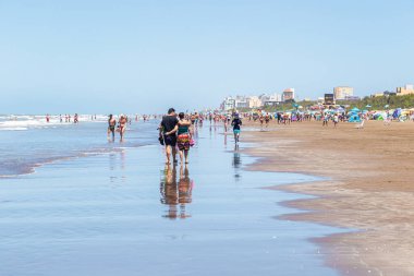 LA LUCILA DEL MAR, BUENOS AIRES, ARGENTINA - JANUARY 12, 2022: View of beach life on a summer day. Tourists enjoy the January holidays on the Atlantic coast.
