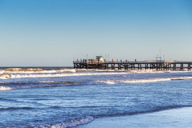 LA LUCILA DEL MAR, BUENOS AIRES, ARGENTINA - JANUARY 12, 2022: View of the famous fishing pier. Day of summer in January vacations.