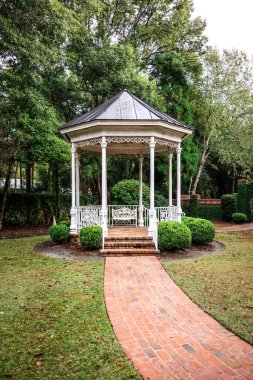 A small gazebo with a brick pathway.