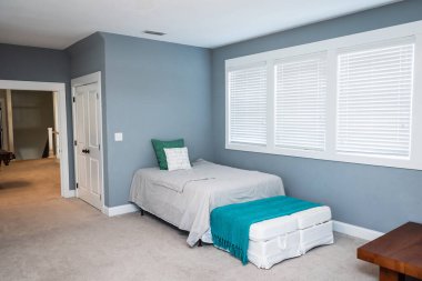 An extra bed for guests in a new construction upstairs bonus room.