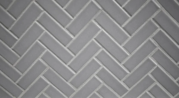 Gray Grey porcelain ceramic herringbone tile for a backsplash, kitchen, shower or bathroom.