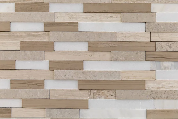 Brown, beige and white accent tile for backsplash, kitchen, shower or bathroom walls made of stone.