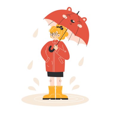 Sonbahar montlu küçük kız ve sarı çizmeli çocuk şemsiyeli su birikintisinde duruyor.