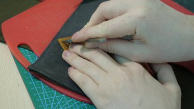 cutting the red paper with a knife on a white background