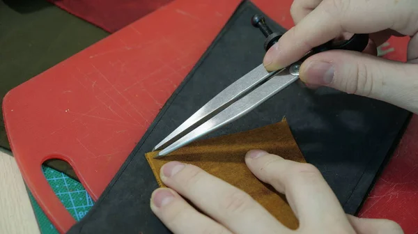 cutting the red paper with a knife