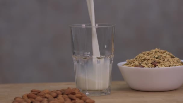 Nalijte Mléko Sklenice Položené Stole Obsahuje Mandlová Semena Umístěte Dřevěný — Stock video