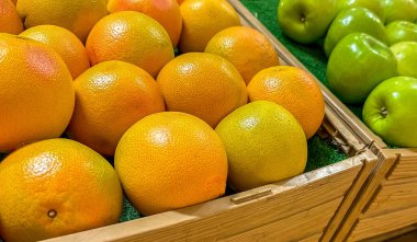 Olgun portakallar ve elmalar kutularda, yakın çekim görüntüsü 