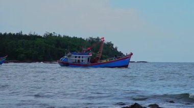 Quang Ngai, Vietnam - 8 Haziran 2023: Balıkçı gemileri ve balıkçı teknelerinin denize açılma görüntüleri. An Vinh Ekspres yüksek hızlı nakliye treni Sa Ky sahnesine doğru ilerliyor.