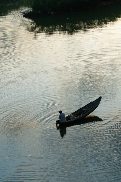 stock image Quang Ngai, Vietnam - June 2023 - A man is casting a fishing net on the Tra Khuc River - Quang Ngai city, in the morning. Angle shot from above.