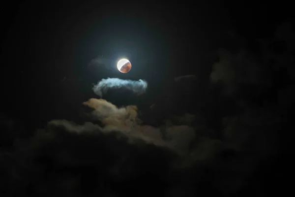 stock image The Full Moon and Lunar Eclipse amongst the clouds in the night sky. Taken at Macmasters Beach, NSW, Australia.