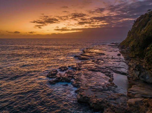 stock image Aerial sunrise at the seaside with rocks at Avoca Beach on the Central Coast, NSW, Australia.