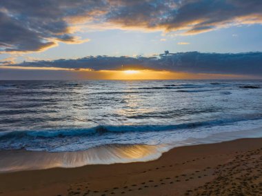 Sunrise seascape with clouds at Blue Bay, NSW, Australia. Blue Bay is a small suburb located between The Entrance and Toowoon Bay on the Central Coast.