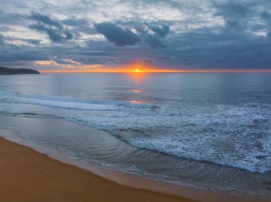 Sunrise seascape with colour and clouds at Killcare Beach on the Central Coast, NSW, Australia.