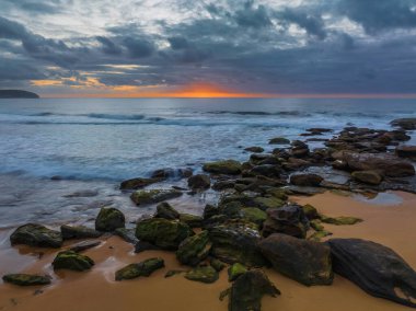 Sunrise seascape with colour and clouds at Killcare Beach on the Central Coast, NSW, Australia.