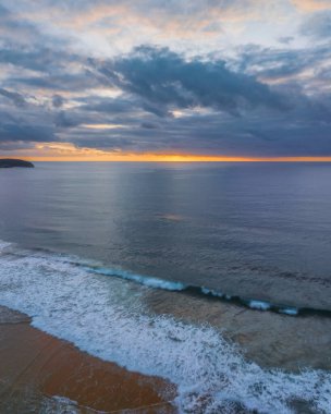 Sunrise seascape with colour and clouds at Killcare Beach on the Central Coast, NSW, Australia.