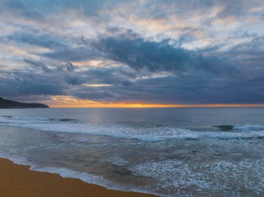 Sunrise seascape with colour and clouds at Killcare Beach on the Central Coast, NSW, Australia.