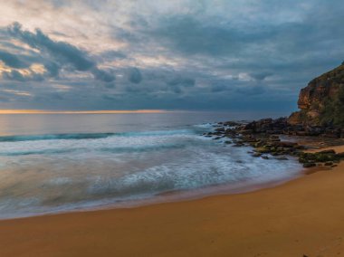 Sunrise seascape with colour and clouds at Killcare Beach on the Central Coast, NSW, Australia.