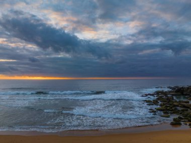 Sunrise seascape with colour and clouds at Killcare Beach on the Central Coast, NSW, Australia.