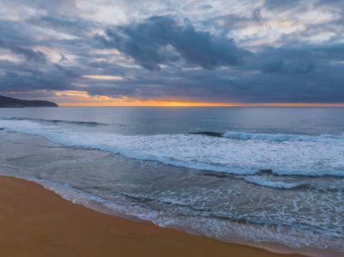 Sunrise seascape with colour and clouds at Killcare Beach on the Central Coast, NSW, Australia.