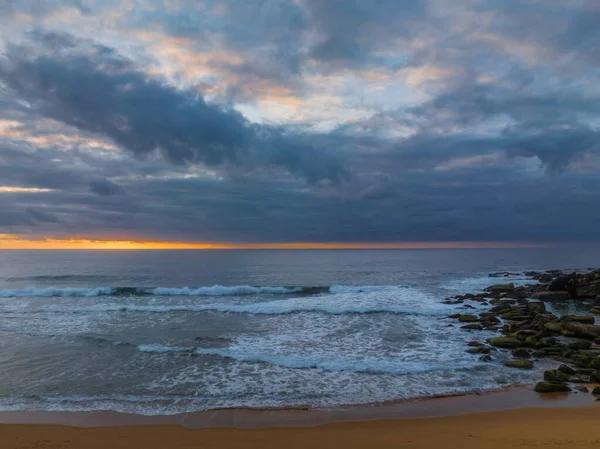 Sunrise seascape with colour and clouds at Killcare Beach on the Central Coast, NSW, Australia.