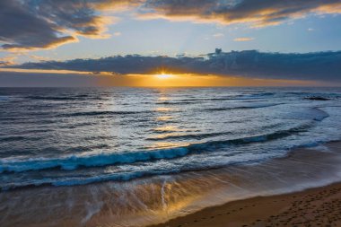 Sunrise seascape with clouds at Blue Bay, NSW, Australia. Blue Bay is a small suburb located between The Entrance and Toowoon Bay on the Central Coast.