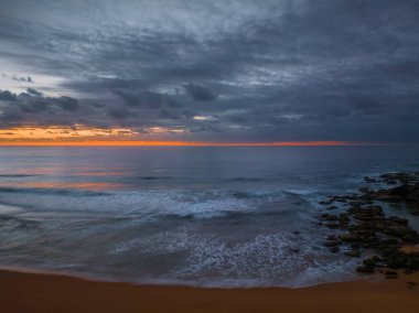 Sunrise seascape with colour and clouds at Killcare Beach on the Central Coast, NSW, Australia.