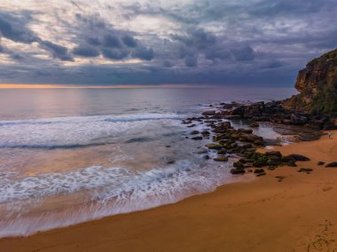 Sunrise seascape with colour and clouds at Killcare Beach on the Central Coast, NSW, Australia.