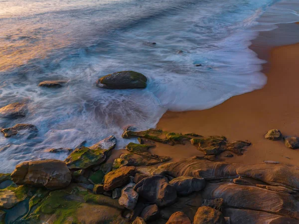 Sunrise from above over the ocean at North Pearl Beach on the Central Coast, NSW, Australia.