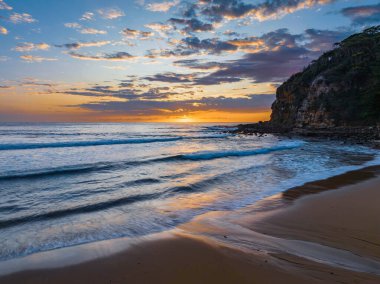 Aerial sunrise seascape with clouds at  Macmasters Beach on the Central Coast, NSW, Australia.