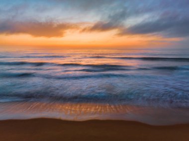 Aerial sunrise seascape with clouds, fog and haze at  Wamberal Beach on the Central Coast, NSW, Australia.