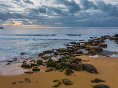 Sunrise seascape with colour and clouds at Killcare Beach on the Central Coast, NSW, Australia.