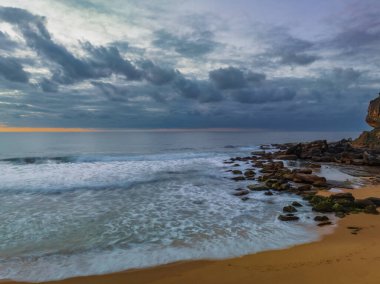 Sunrise seascape with colour and clouds at Killcare Beach on the Central Coast, NSW, Australia.