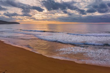 Sunrise seascape with colour and clouds at Killcare Beach on the Central Coast, NSW, Australia.