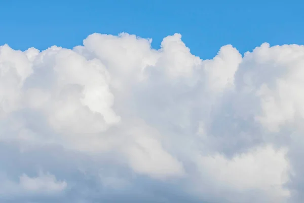 stock image Skyscape background of white clouds set against the soft blue sky in the afternoon light