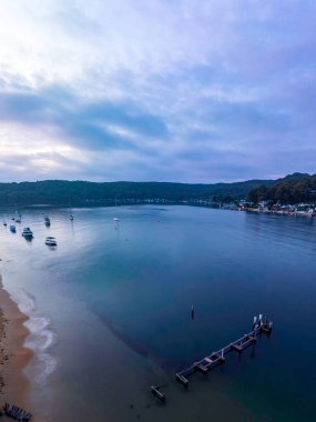 A soft sunrise from the ferry wharf in Ettalong Beach on the Central Coast, NSW, Australia.