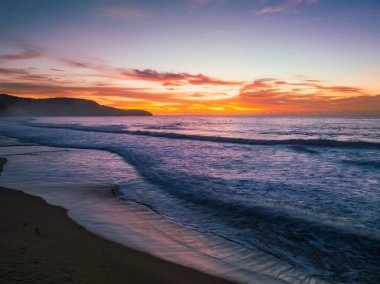 Sunrise seascape with colour and clouds at Killcare Beach on the Central Coast, NSW, Australia.
